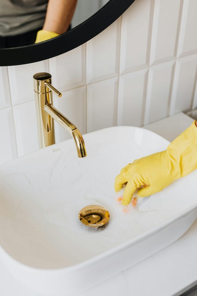 pexels-photo-4239131-4239131 Faceless man cleaning sink in bathroom